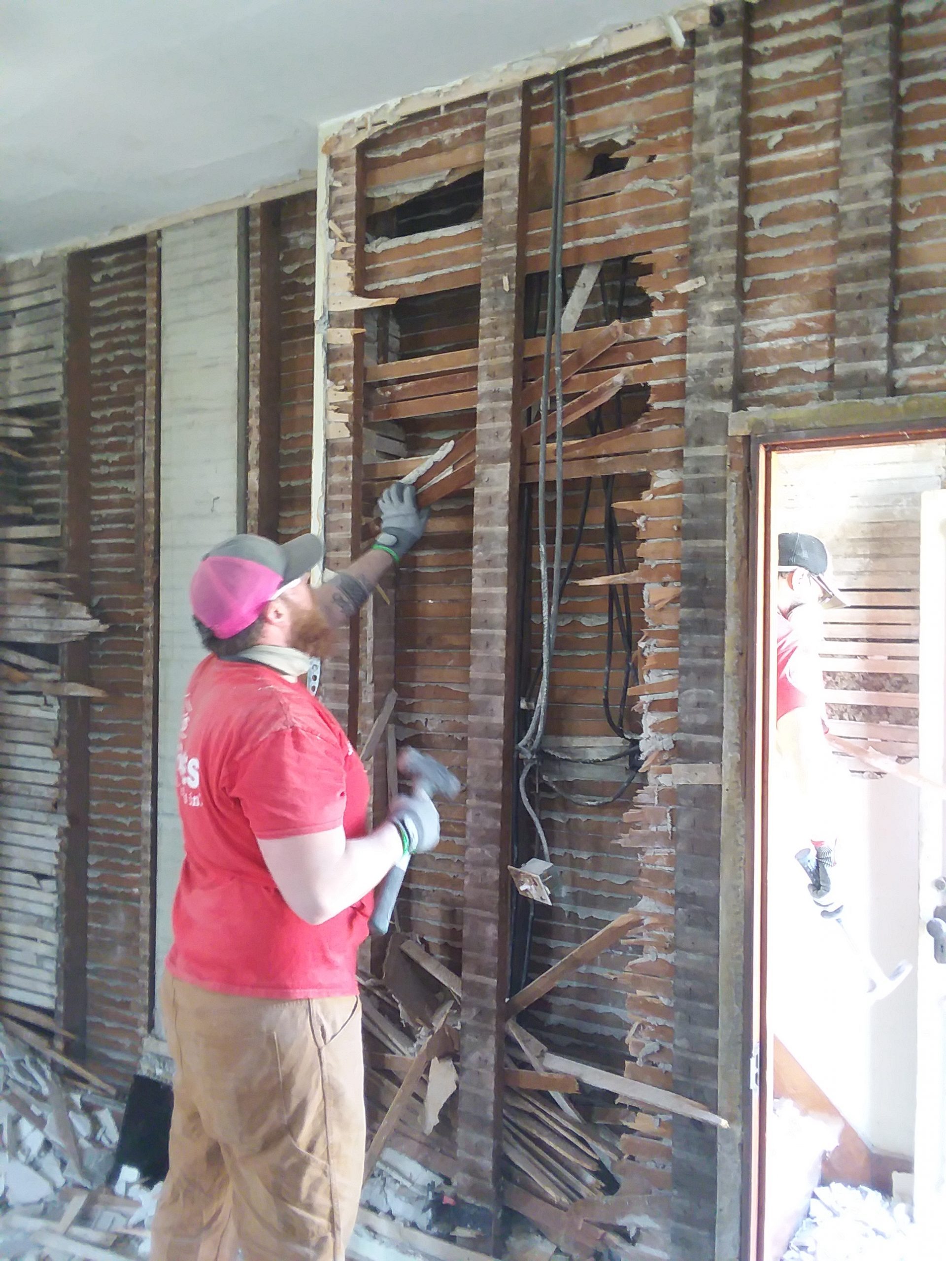 Volunteer doing demolition work